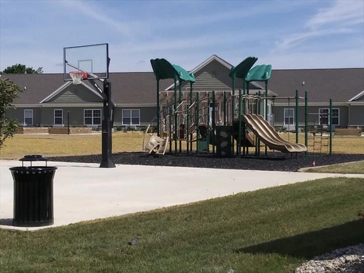 outdoor rec area with basketball hoop and playground