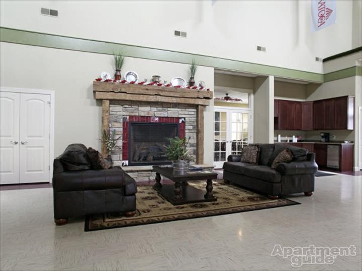 community room with chairs, fireplace, and kitchenette